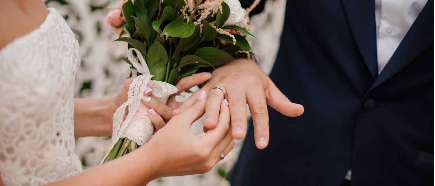 Newlyweds Exchanging Rings Bride Putting The Ring On The Grooms Hand Picture Id928870154