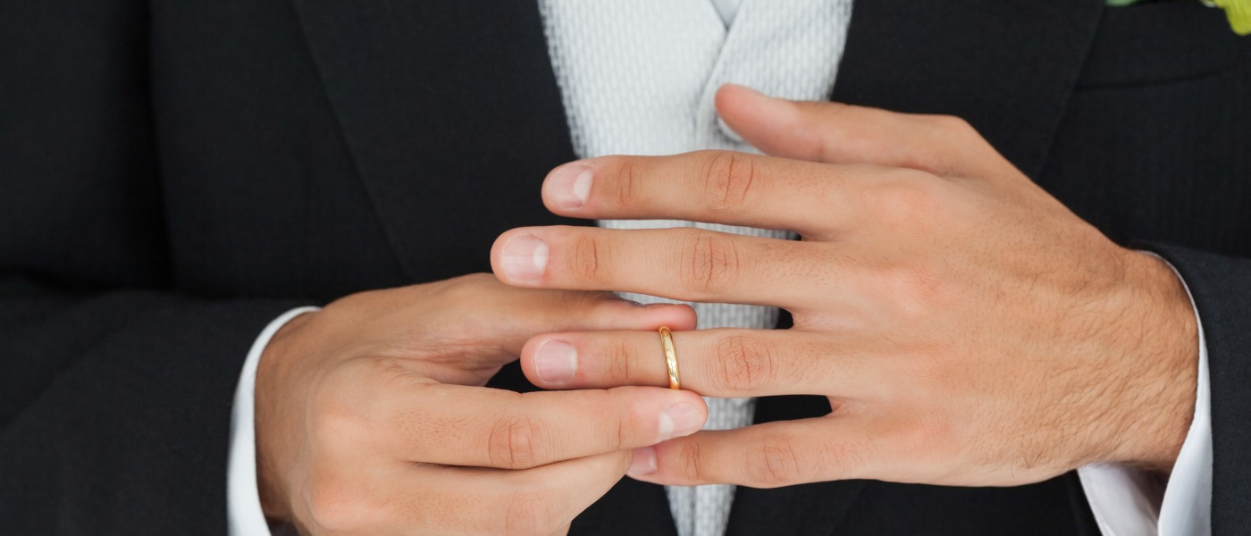 Close Up Of An Elegant Groom Trying His Wedding Ring Picture Id462582231